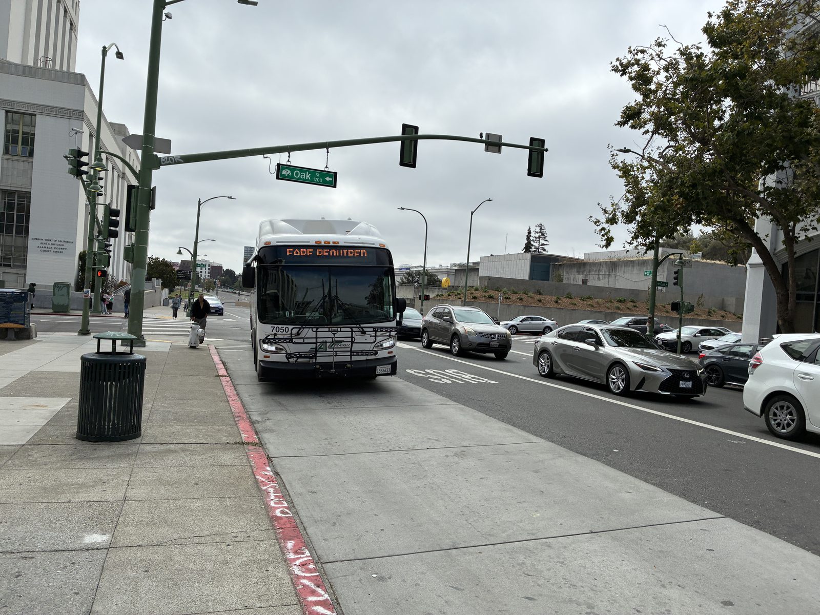 An AC Transit bus pulling in at a downtown Oakland stop