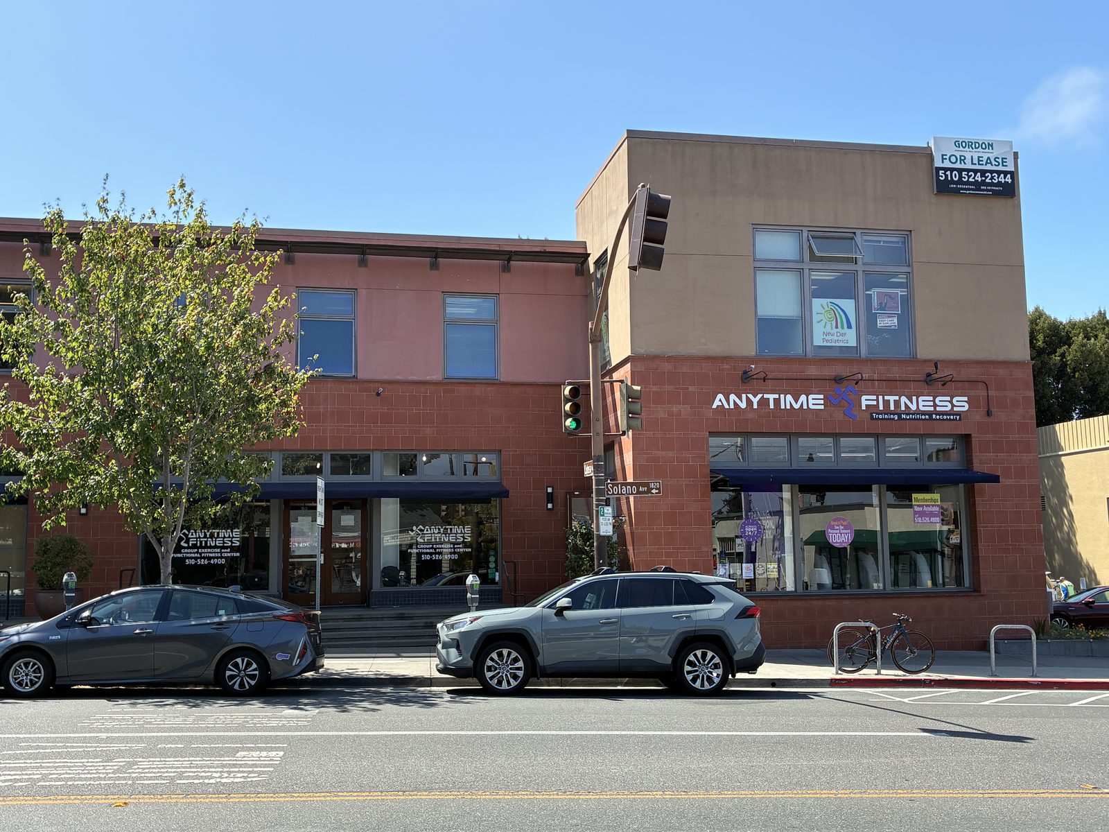 A two-storey corner building on Solano Avenue with a gym on the ground floor