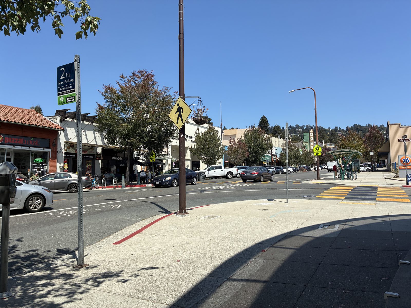 A quiet Solano Avenue corner, a Spanish-tiled roofline and an empty crosswalk